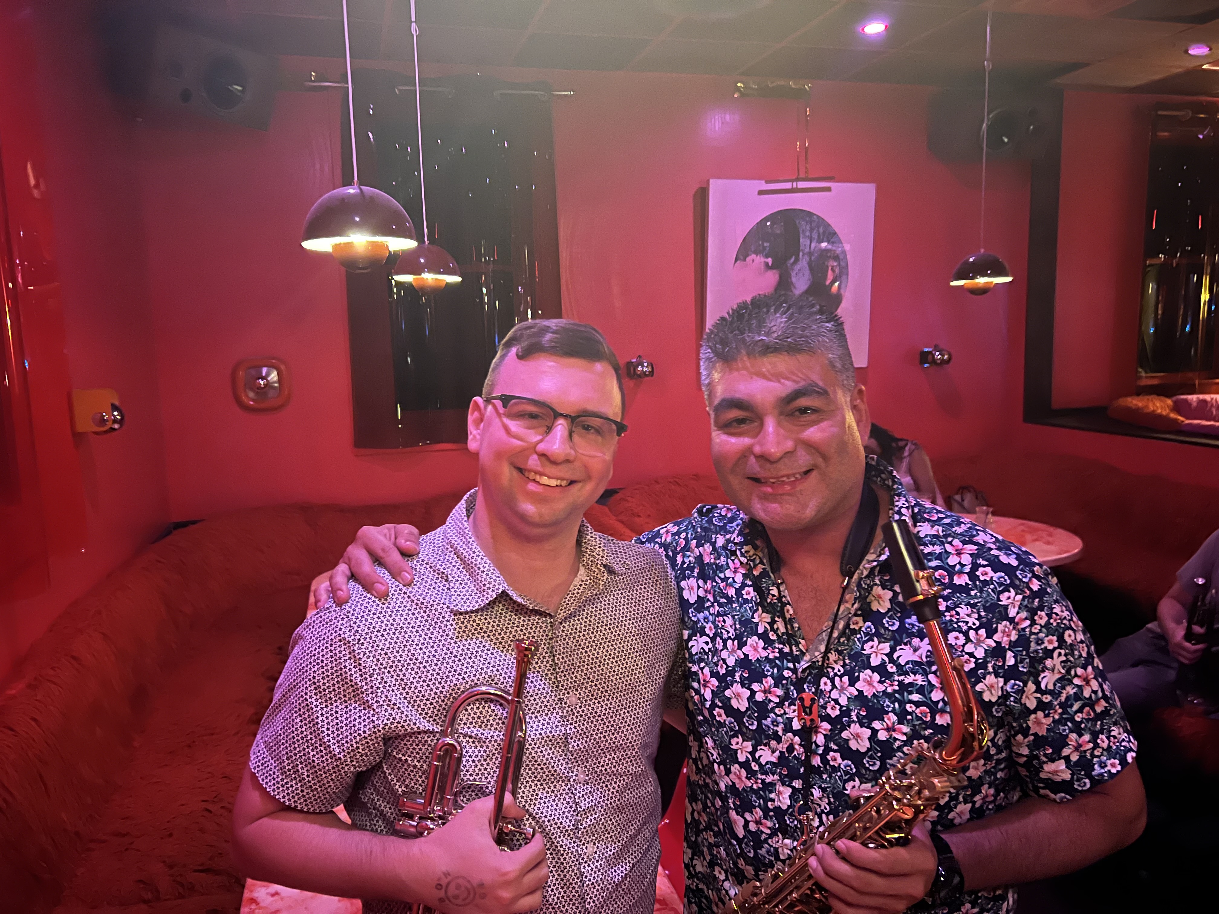 Sean with a saxophonist in the red lounge after a show
